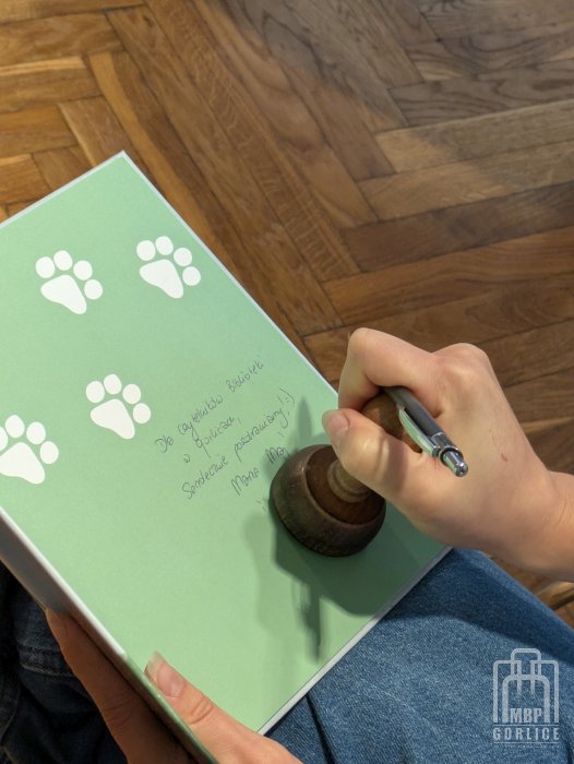 Biblioteka Gorlice, Lato z Biblioteką Autorka wpisuje autograf do ksiązki